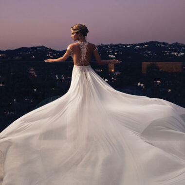 A bride stands on the rooftop in her gown